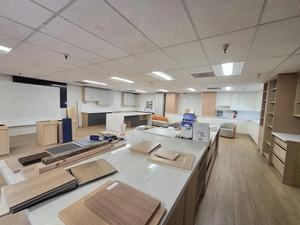 Showroom centerpiece &mdash; kitchen island with quartz countertop and cabinet samples