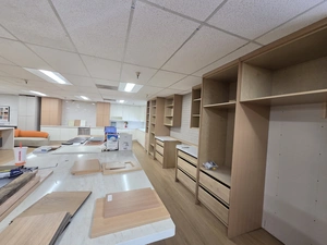 Open cabinet boxes on display along the showroom wall