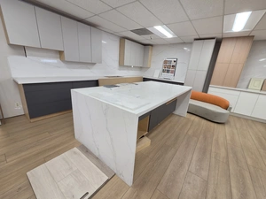 Modern white shaker kitchen vignette with quartz waterfall island