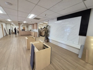 Showroom corner with cabinet bases and a marble slab feature wall