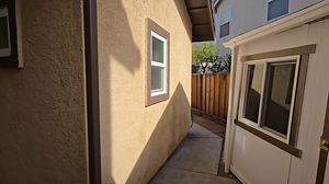 Narrow Side Yard Passage Between Main House and Shed