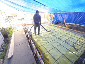 Beginning of Concrete Pour Over Vapor Barrier