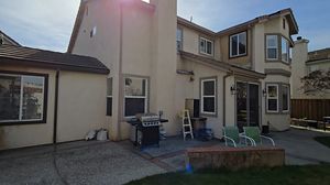 Rear View of House with Patio and BBQ Grill