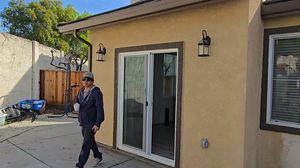 Sliding Glass Door Entrance with Homeowner Holding Coffee