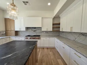 9Builders: Spacious Kitchen with Elegant Lighting and Marble Countertops