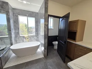 9Builders: High-End Bathroom Remodel Featuring Custom Cabinets and Marble