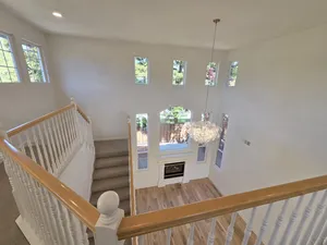 9Builders: Spacious and Bright Living Area with Custom Staircase and Lighting