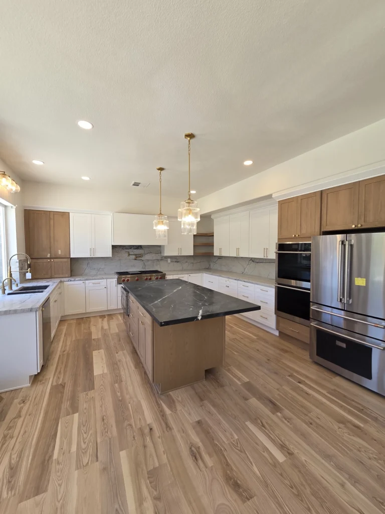 Spacious Kitchen Area with Island and Concrete Countertop