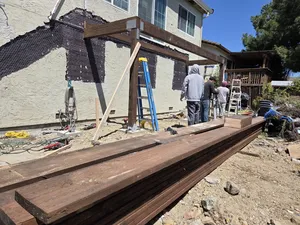Workers preparing lumber for installation