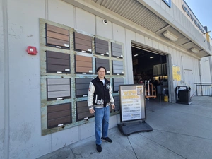 9Builders rep at the open-to-the-public entrance with composite decking samples