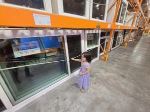 Young visitor inspecting a sliding glass patio door display