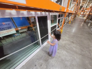 9Builders client family walking past sliding patio door display