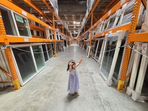 Young visitor pointing up at the warehouse ceiling