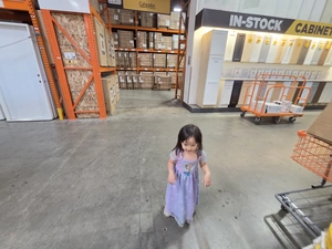Young visitor near the In-Stock Cabinets shopping cart row