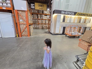 Young visitor approaching the In-Stock Cabinets & Doors display