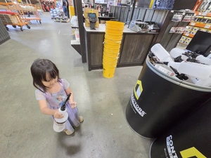 Young visitor near a Contractor's Choice product display