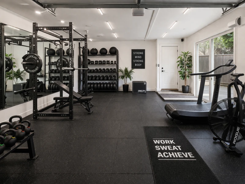 Home gym conversion Bay Area garage with rubber flooring and mirrored wall